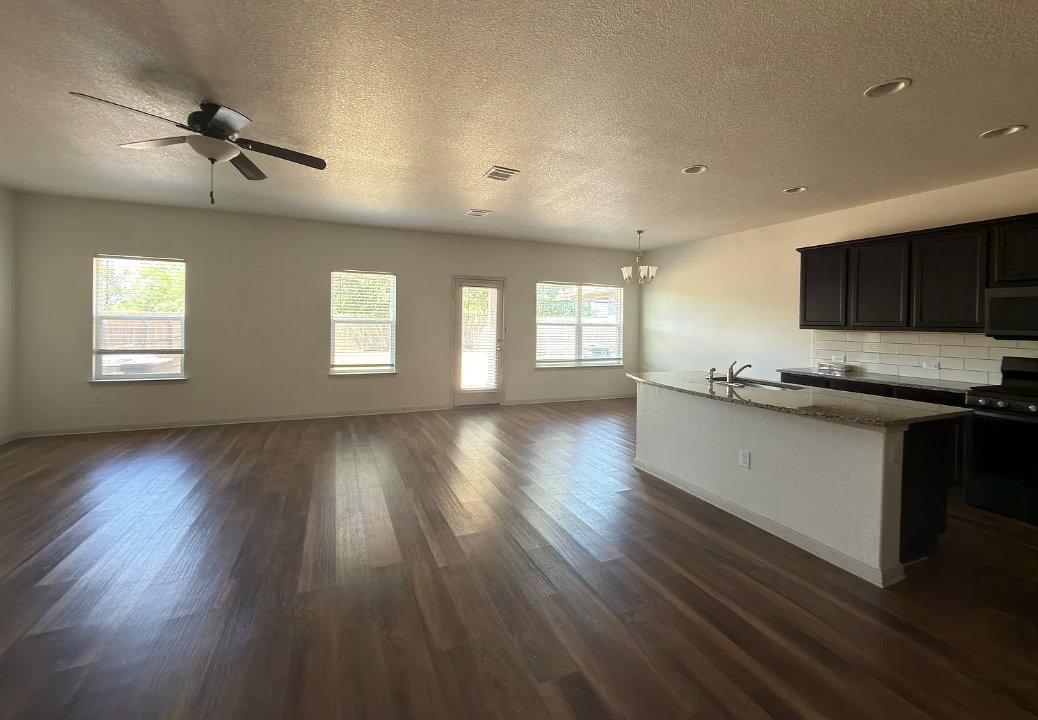 Open living room and kitchen at 1440 Fairhaven Gtwy in Georgetown, Texas